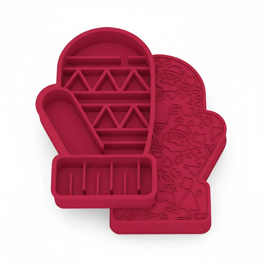 Red two-sided Christmas glove slow feeder bowl for dogs, featuring easy-grip ridges on one side and detailed Santa, bell, and tree patterns on the reverse for multi-level slow feeding.​​